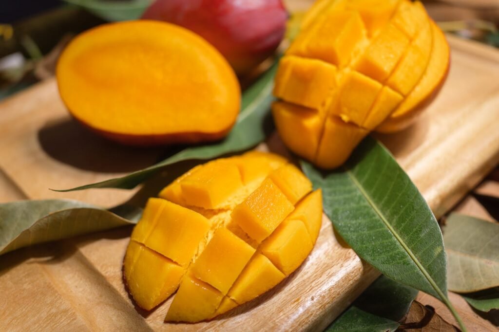 Cutting 2 mangos in a chopping broad