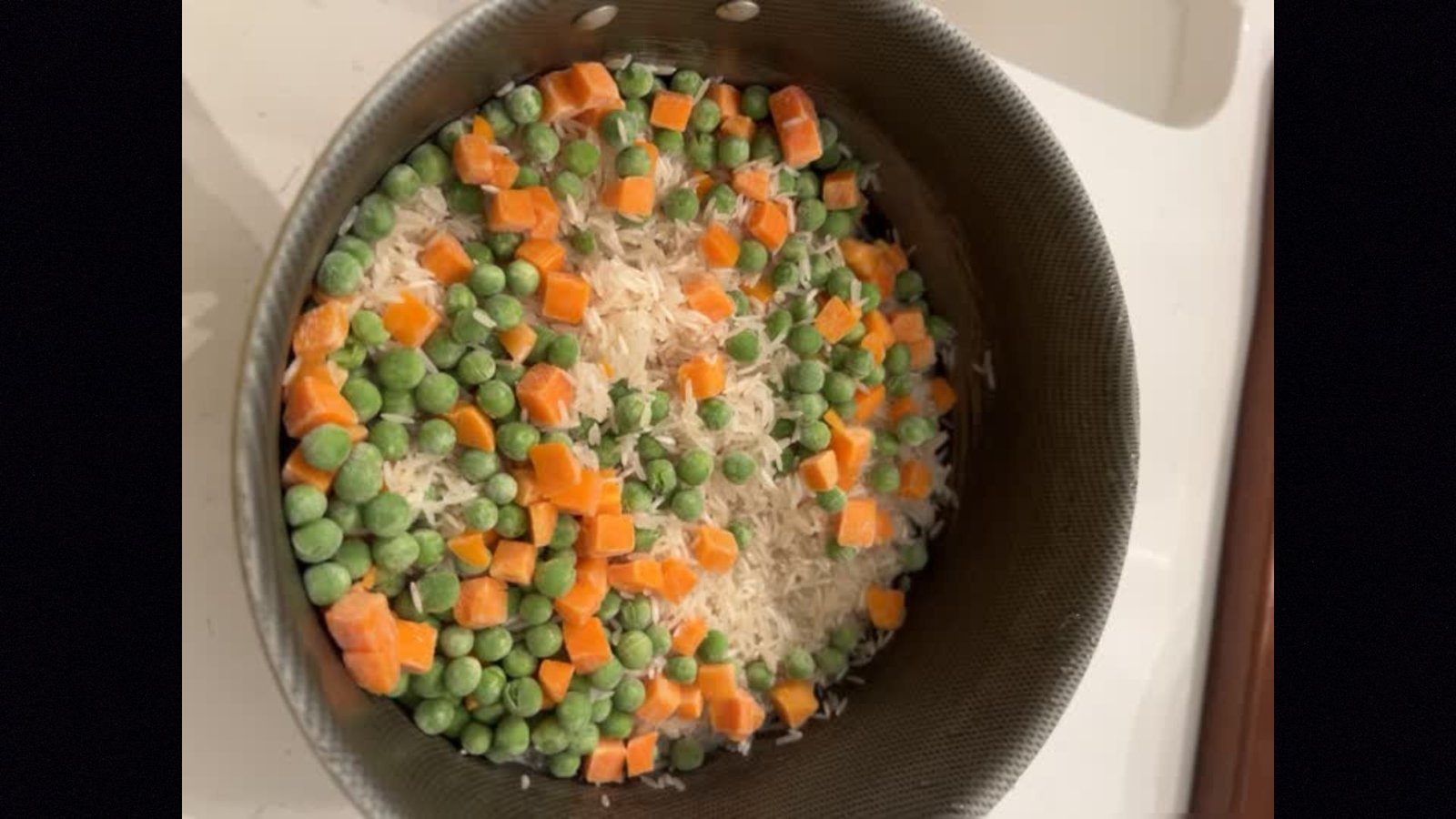 Mixture of peas, carrots and basmati rice in a bowl