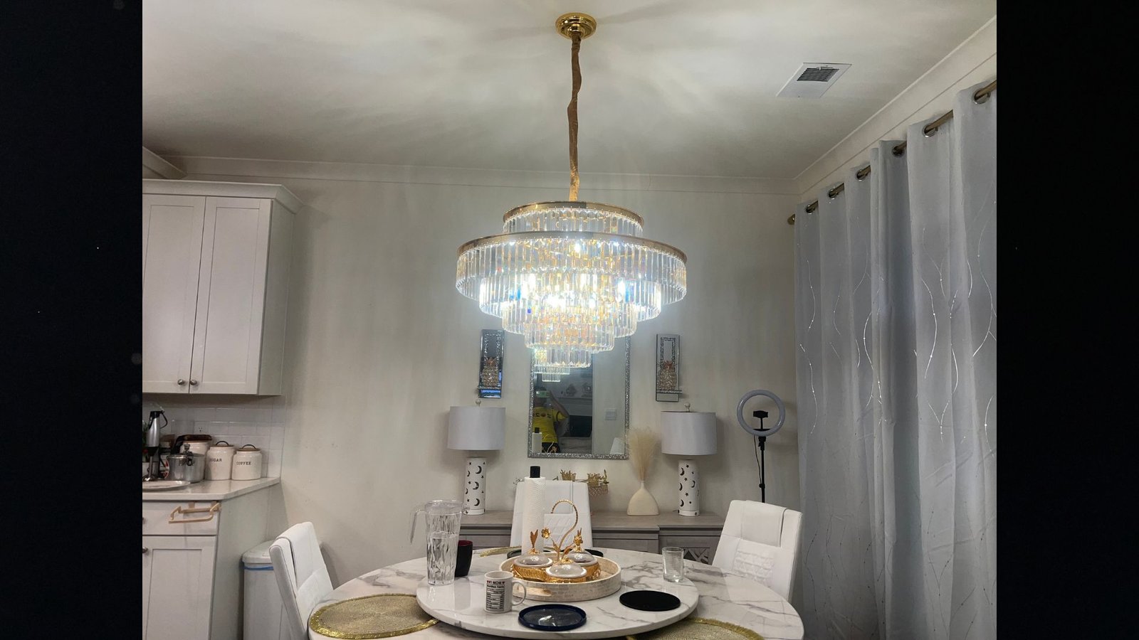 Chandelier light install with wire at ceiling maintaining distance from floor