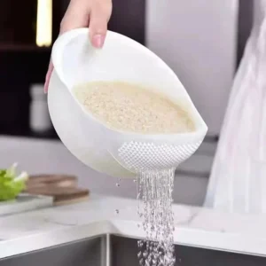 washing rice at colander at home