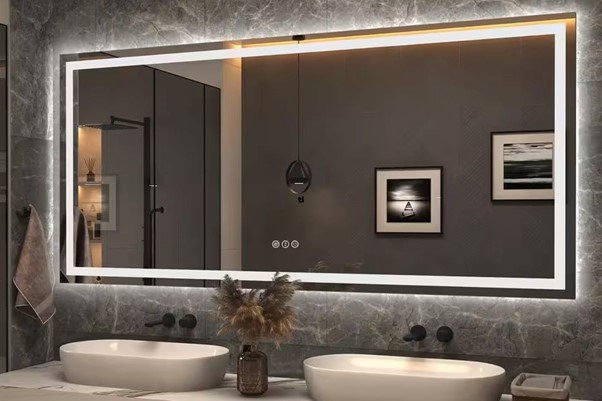 a bathroom mirror is hanging in the wall with LED lights