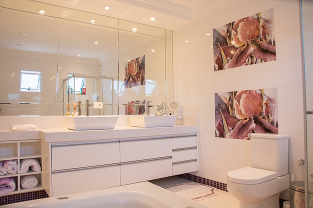 mirror in the washroom with wallpaper and cabinet 