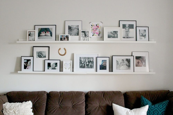 living room decorated with line of picture ledges