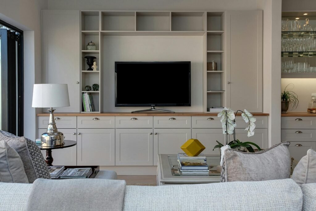 Living room decorated with furniture where tv set high mount on the wall