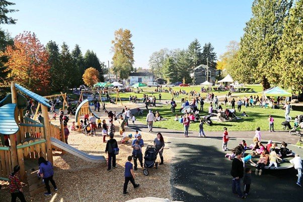 a palyground where it representing lot of trees and people