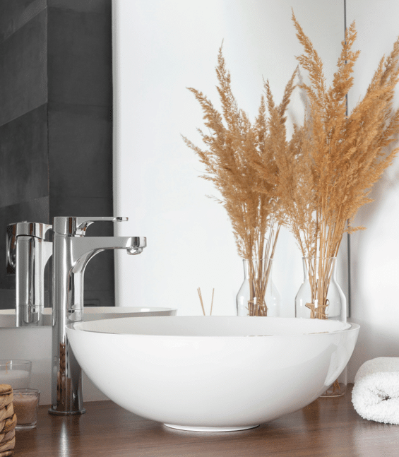 a single room bathroom vanity is organized with lights, trees