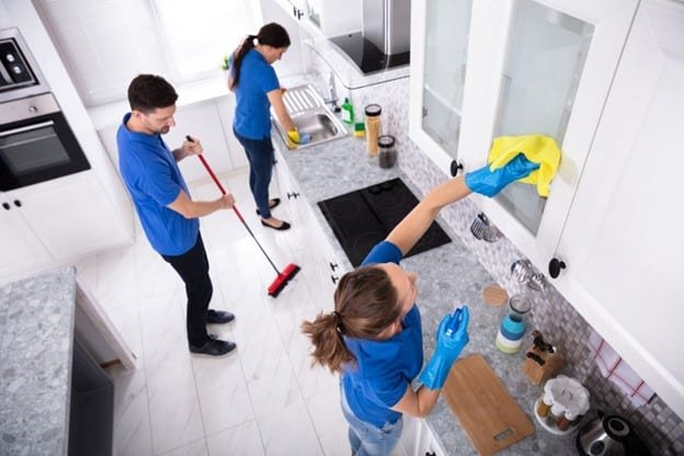 few people are cleaning kitchen at myrtle beach SC in a home representing House Cleaning Rates Per Hour Near Myrtle Beach, SC