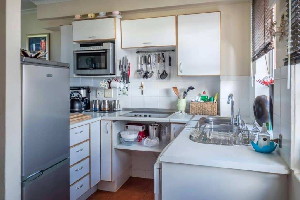 Sophisticated kitchen interior with modern appliances, wooden accents, and functional design representing Kitchen Counter Organization Ideas.